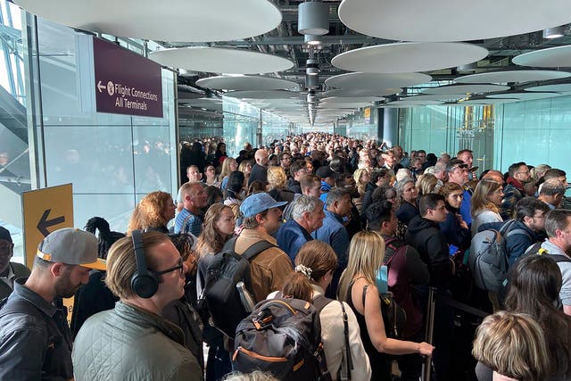 <p>People queue at arrivals at Heathrow airport in London on Saturday</p>