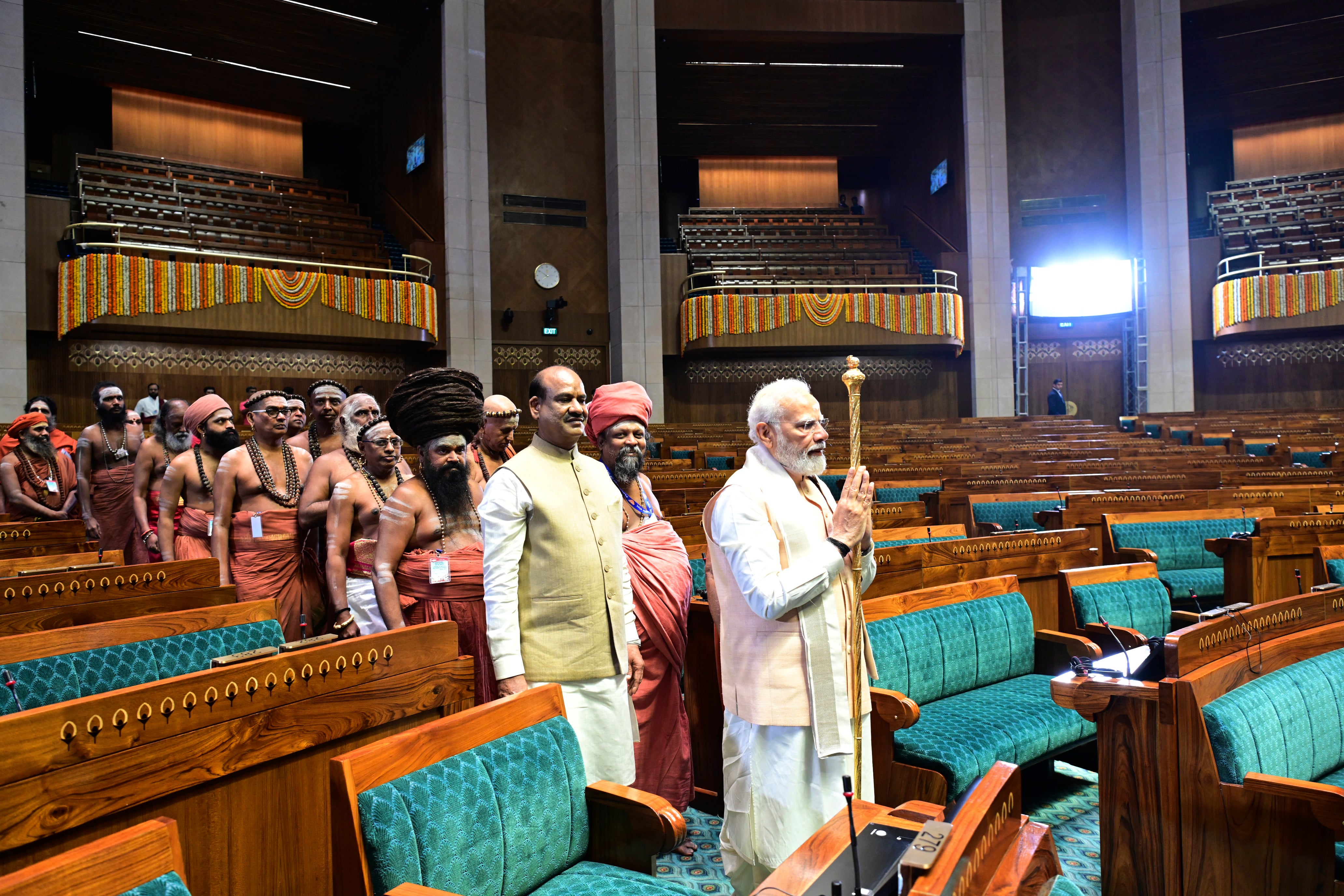 Narendra Modi carries the royal golden sceptre to be installed near the speaker’s chair in the new parliament building