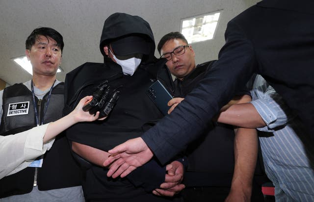 <p>A man who opened an emergency exit door during a flight, arrives to attend an arrest warrant review at the Daegu district court in Daegu</p>