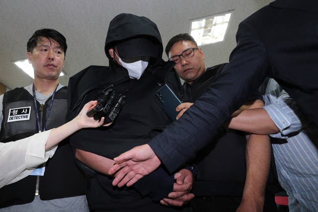 <p>A man who opened an emergency exit door during a flight, arrives to attend an arrest warrant review at the Daegu district court in Daegu</p>