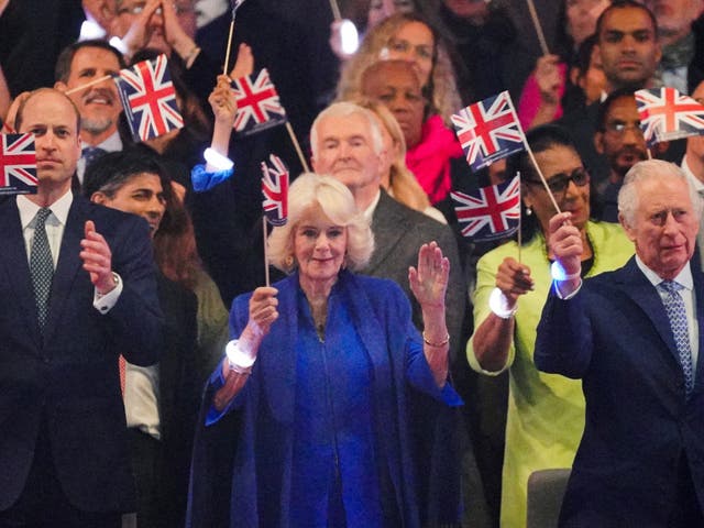 <p>The Prince of Wales, King Charles III and Queen Camilla in the Royal Box viewing the Coronation Concert wearing the wristbands</p>