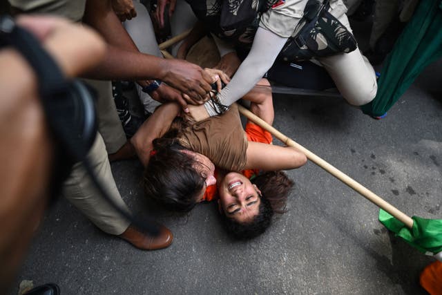 <p>Indian wrestlers Sangeeta Phogat and Vinesh Phogat struggle as they are detained by the police while attempting to march to India's new parliament, just as it was being inaugurated by prime minister Narendra Modi, during a protest against Brij Bhushan Singh, the wrestling federation chief, over allegations of sexual harassment and intimidation</p>