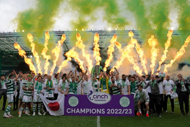 Celtic players lifted the league trophy after a 5-0 win at home (Andrew Milligan/PA)