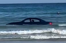 ‘You can’t park there’: Coastguard called to BMW stranded out at sea on Cornish beach