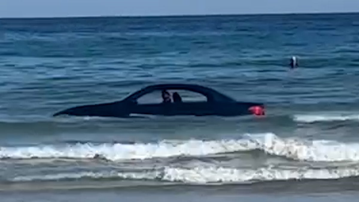 ‘You can’t park there’: Coastguard called to BMW stranded out at sea on Cornish beach