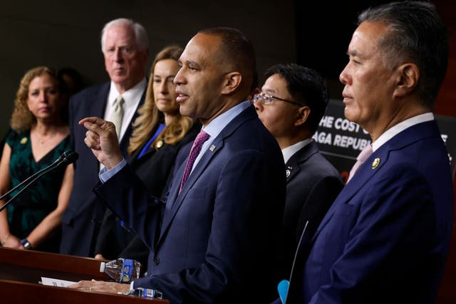 <p>Hakeem Jeffries speaks at a press conference, surrounded by members of the House Democratic caucus</p>