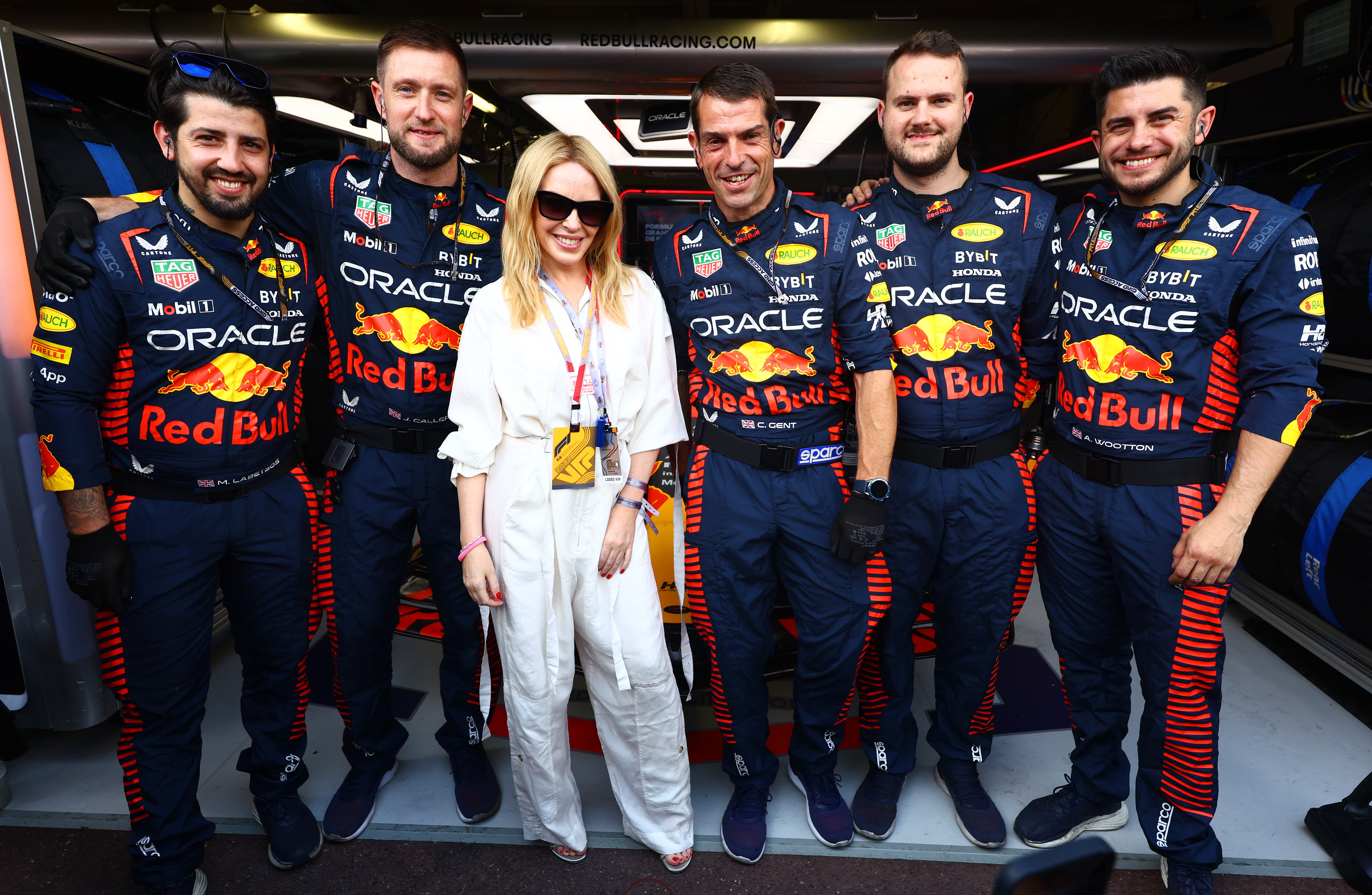 Kylie Minogue and Red Bull Racing team members pose for a photo in the garage during the F1 Grand Prix of Monaco at Circuit de Monaco on May 28, 2023