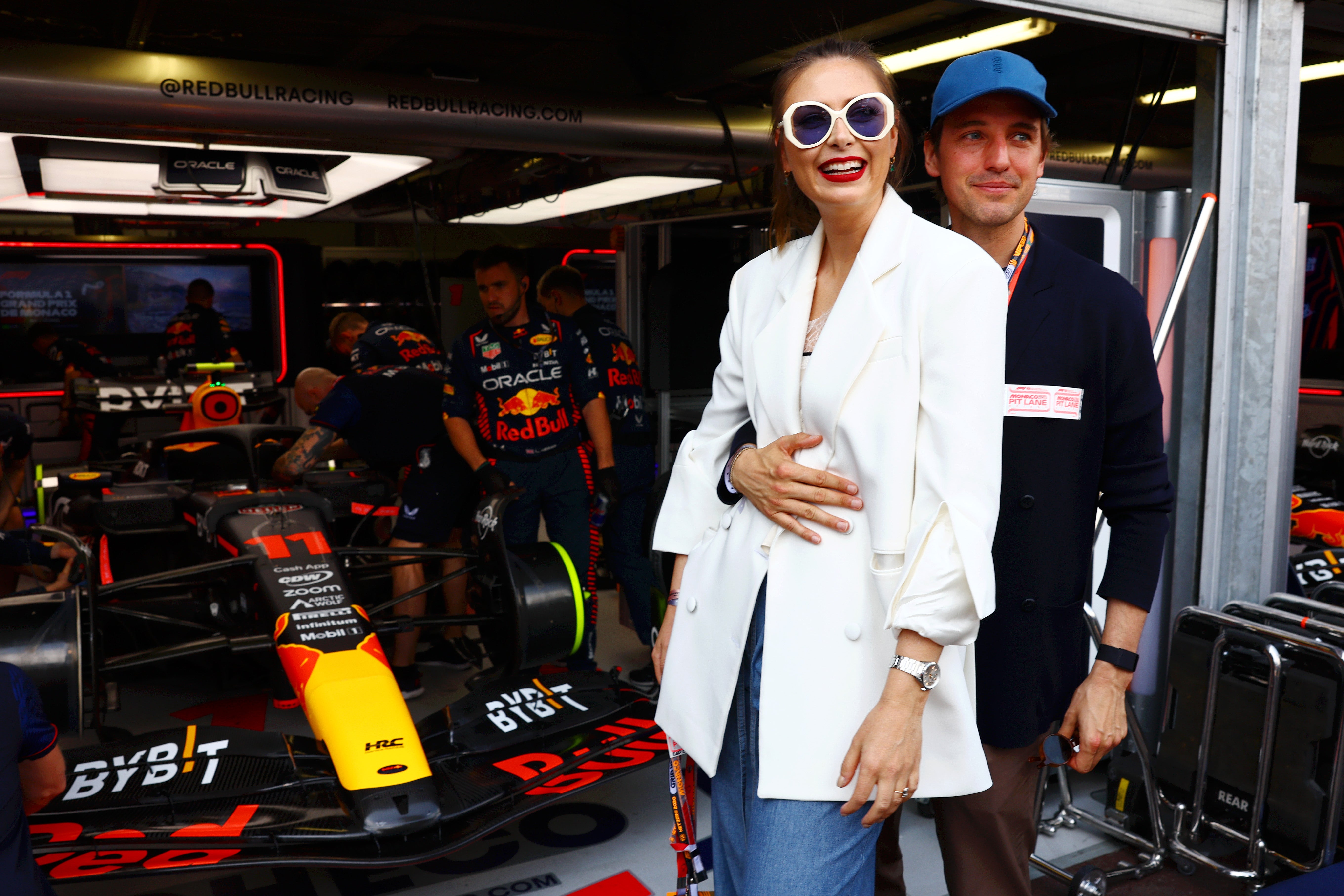 Maria Sharapova and Alexander Gilkes pose for a photo next to the car of Sergio Perez of Mexico and Oracle Red Bull Racing in the garage during the F1 Grand Prix of Monaco at Circuit de Monaco
