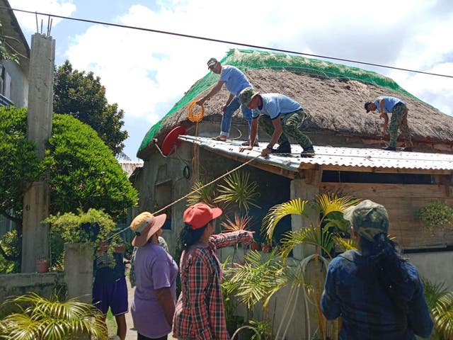 <p>Police help residents reinforce the roof of their homes in Ivana town, Batanes province, on the very tip of the Philippines</p>