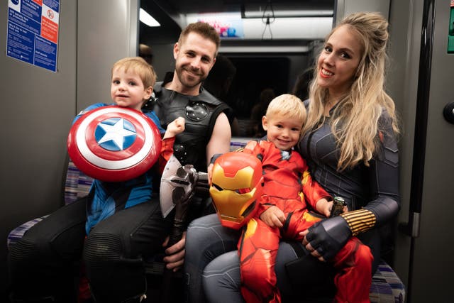 A family travel on the Elizabeth Line to MCM Comic-Con at ExCel London (James Manning/PA)