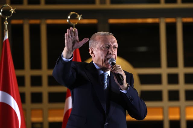 <p>Erdogan addresses supporters outside his palace in Ankara on Sunday evening </p>