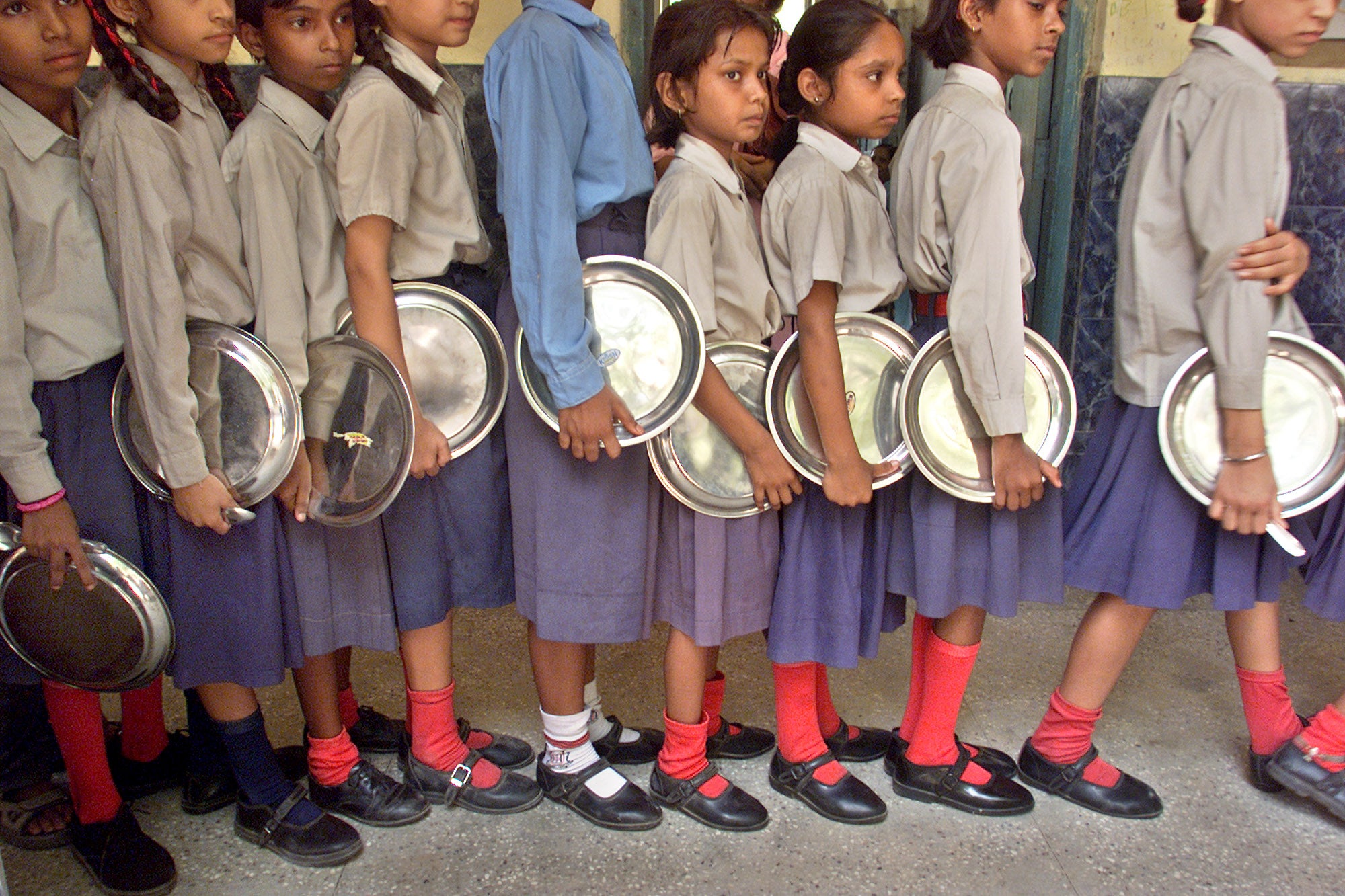 File image: Students wait in a queue to get their lunches in India