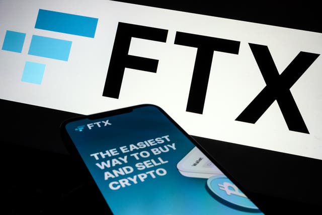 <p>In this photo illustration the FTX logo and mobile app adverts are displayed on screens on November 10, 2022 in London, England</p>