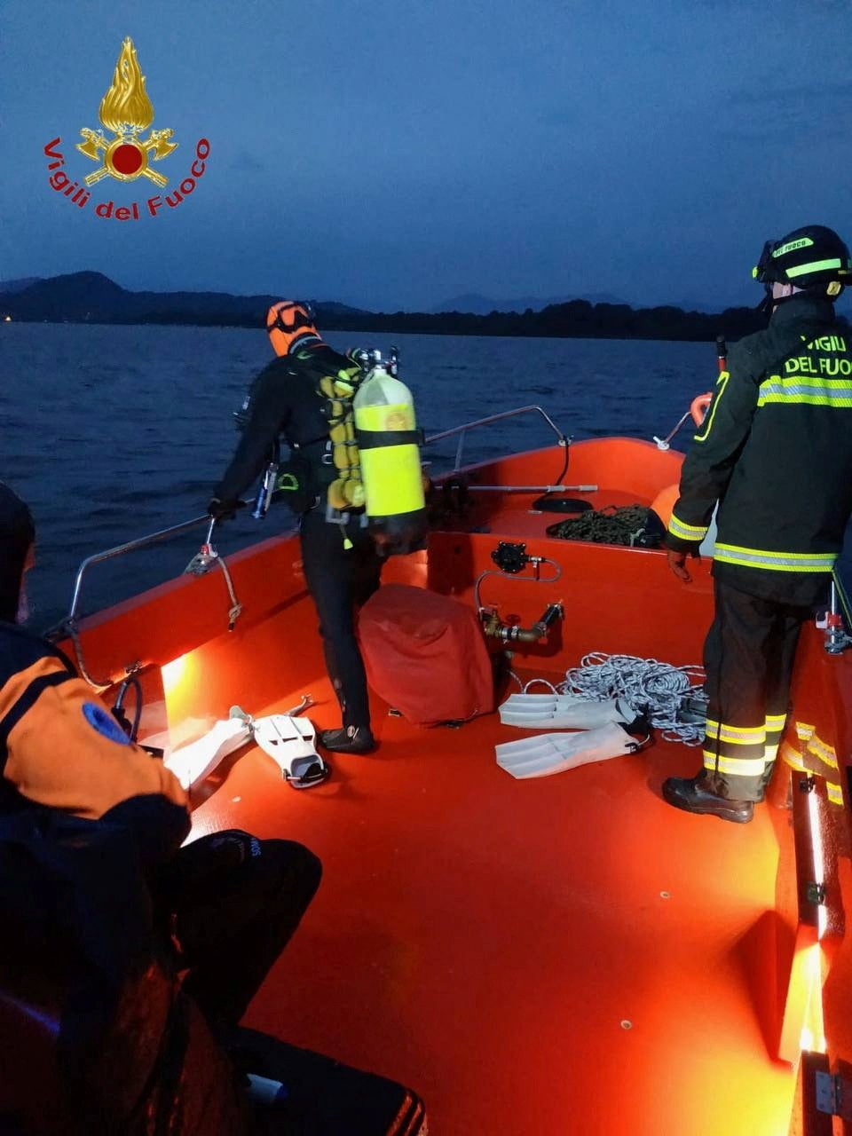 Firefighters search for survivors after the tourist boat capsized in Lake Maggiore