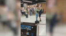 Moment man proposes to Ryanair flight attendant in front of cheering airport crowd