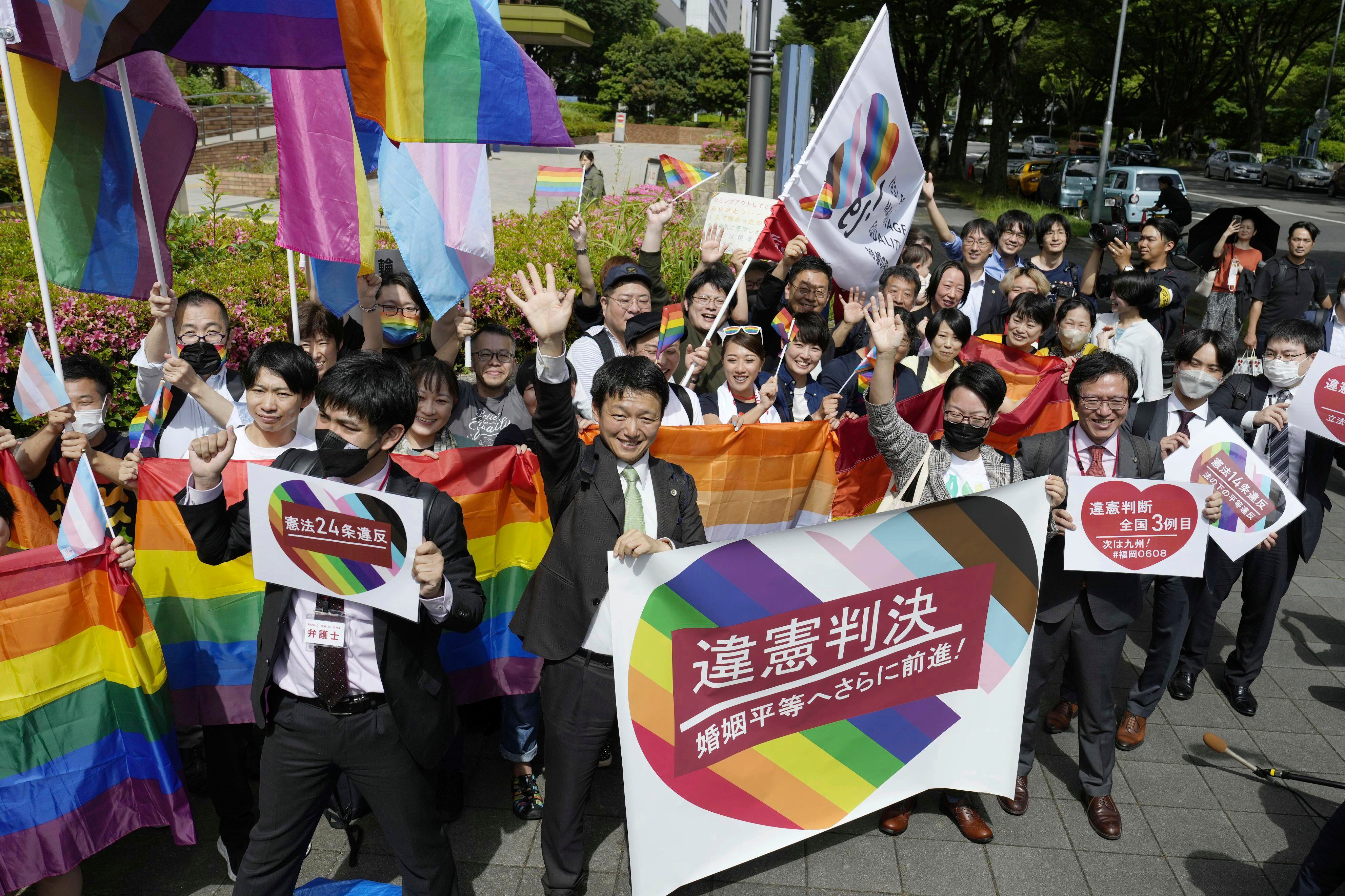 Lawyers of plaintiffs and supporters celebrate following a ruling in front of the Nagoya District Court in Nagoya, central Japan