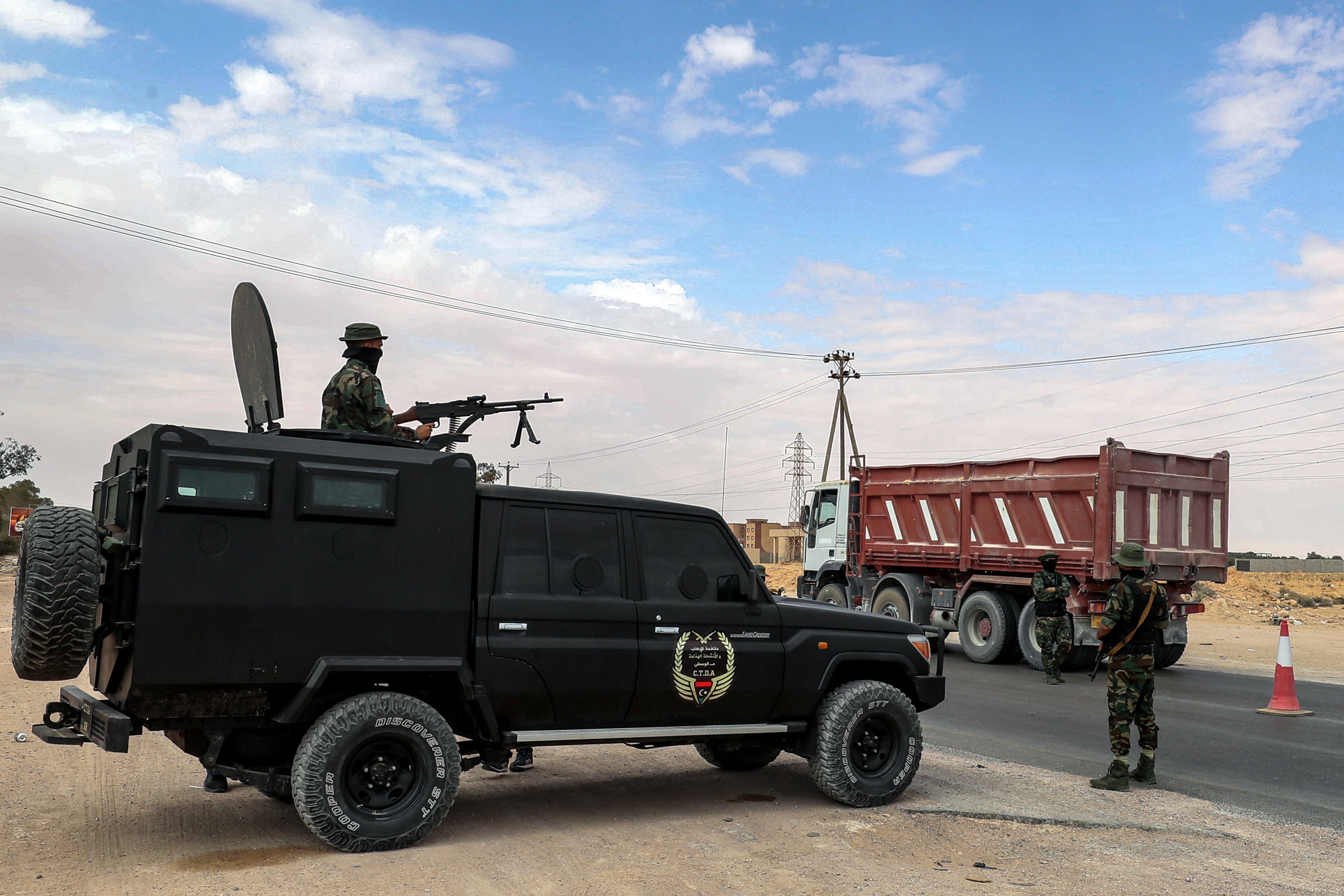 Libyan security forces man a check point in the surrounding area during the trial of jihadists accused of being members of the Isis, in the northwestern city of Misrata on 29 May 2023