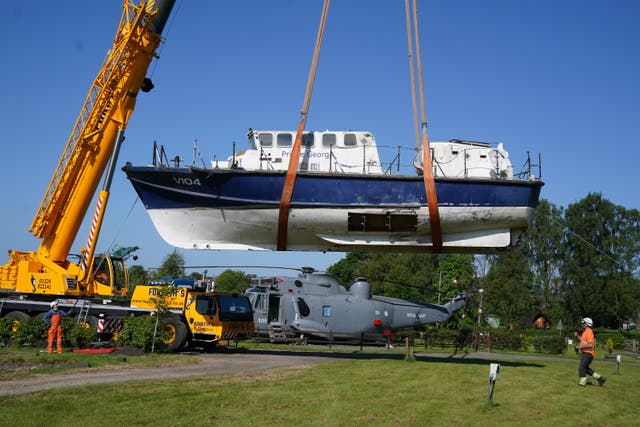 The former RNLI lifeboat is lowered into Martyn Steedman’s camping site at Mains Farm in Thornhill, Stirlingshire (Andrew Milligan/PA)
