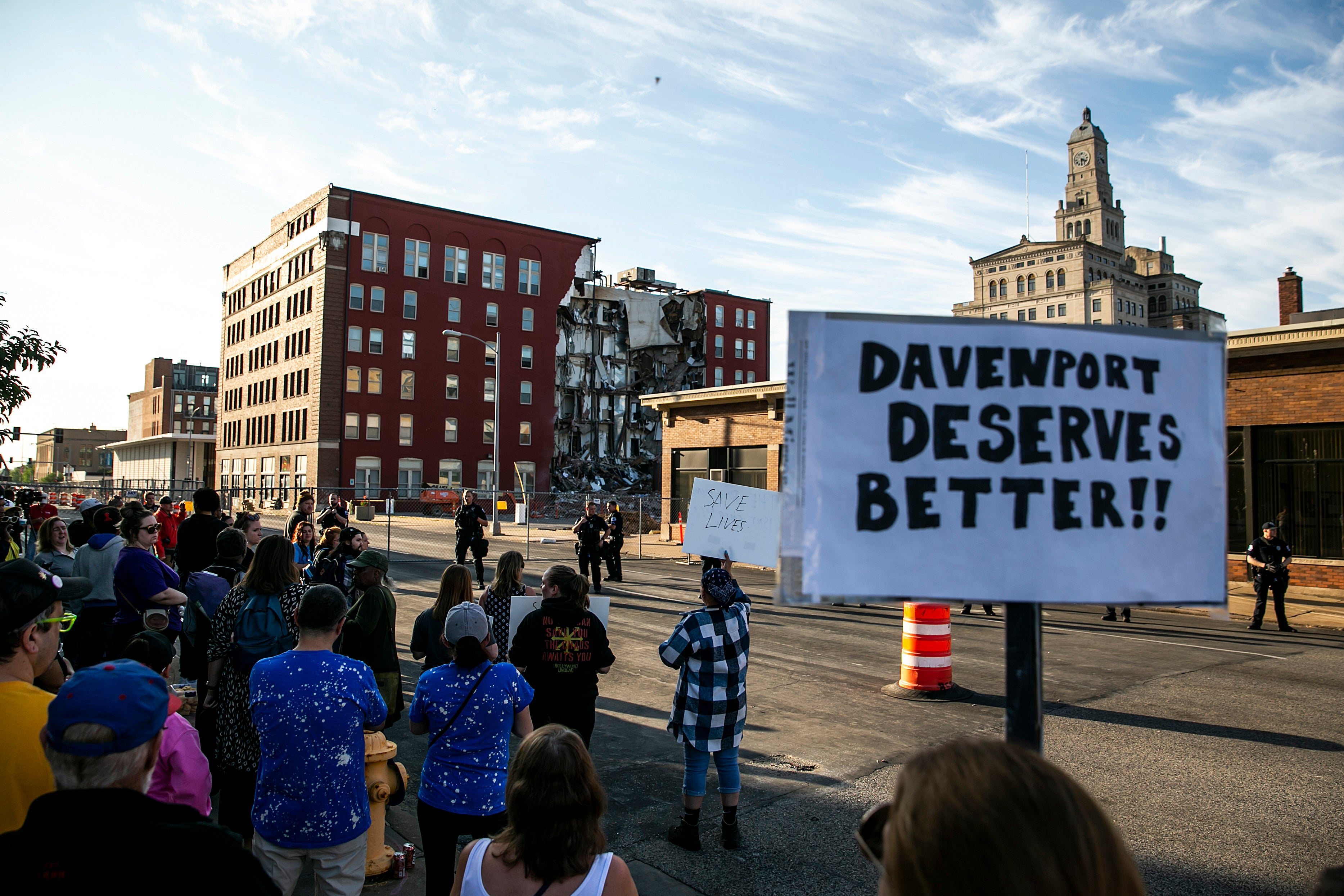 Protesters at the site of a building collapse in Davenport