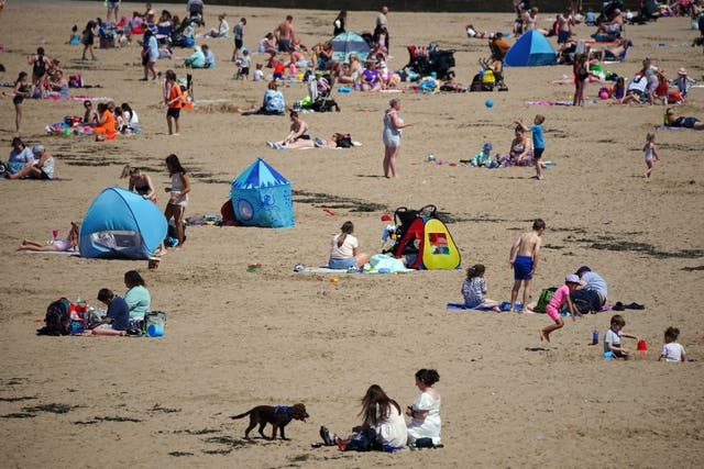 <p>People on the beach at New Brighton on the Wirral, Merseyside, enjoying the warm weather</p>