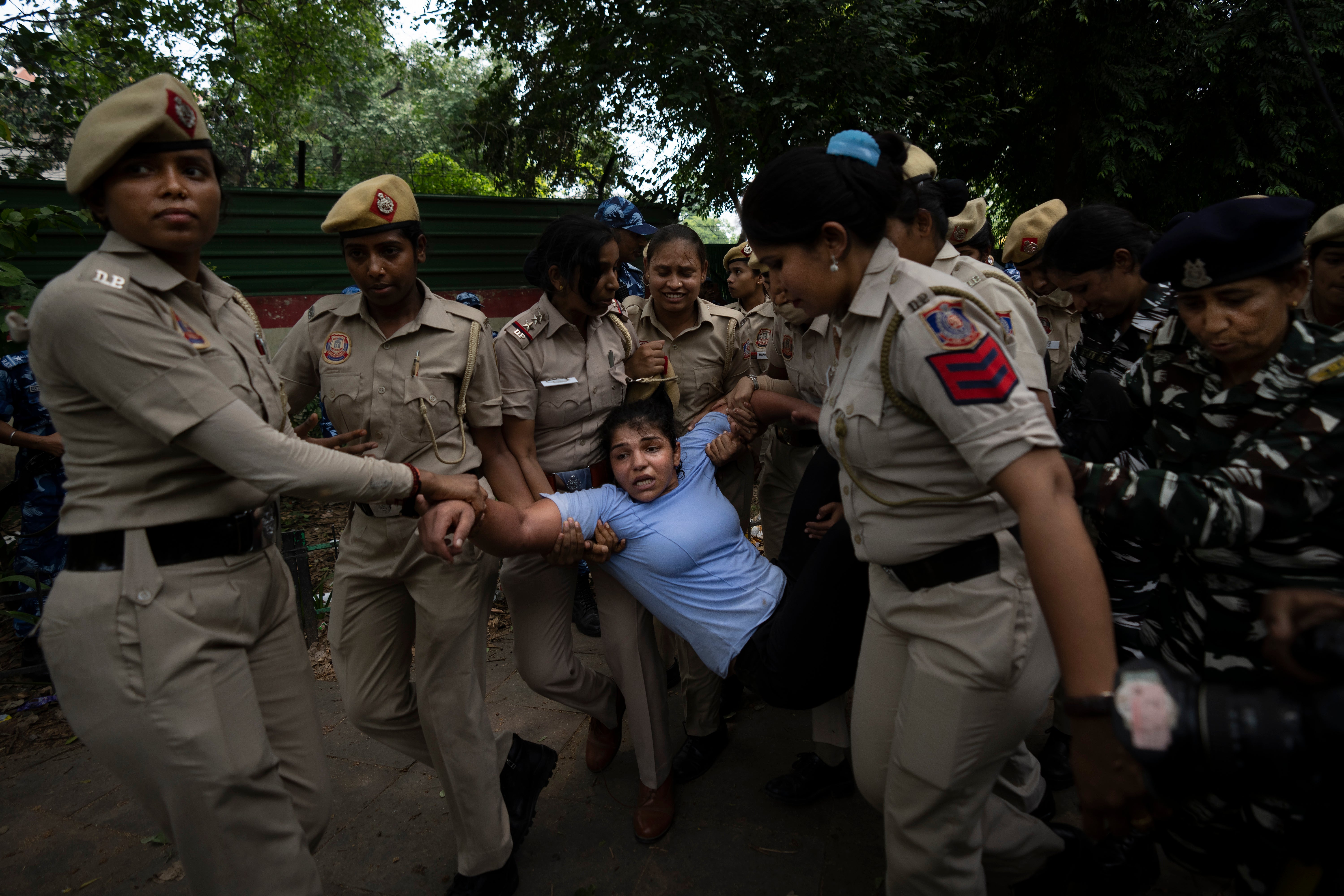 Sakshi Malik, an Indian wrestler who won a bronze medal at the 2016 Summer Olympics, is detained by the police during a protest against Brij Bhushan Sharan Singh, the president of the Wrestling Federation of India, in New Delhi