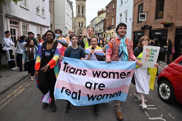 <p>President of Oxford University LGBTQ+ Society Amiad Haran Diman (second right) holds a banner during protests against feminist philosopher Kathleen Stock on Tuesday</p>
