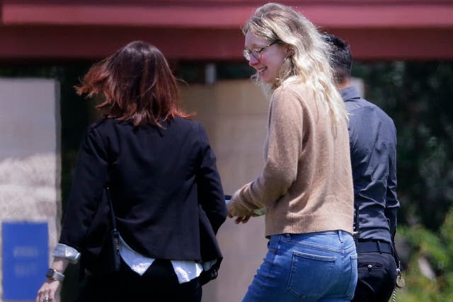 <p>Elizabeth Holmes is escorted to prison to begin her 11-year sentence </p>