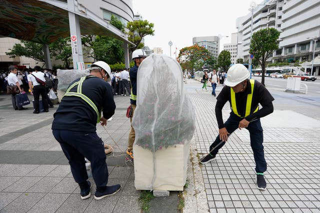 <p>Custodians cover plants with a net in preparation for typhoon Mawar in Naha, southern Japan, Wednesday, 31 May 2023, as it was moving towards the Okinawa islands</p>
