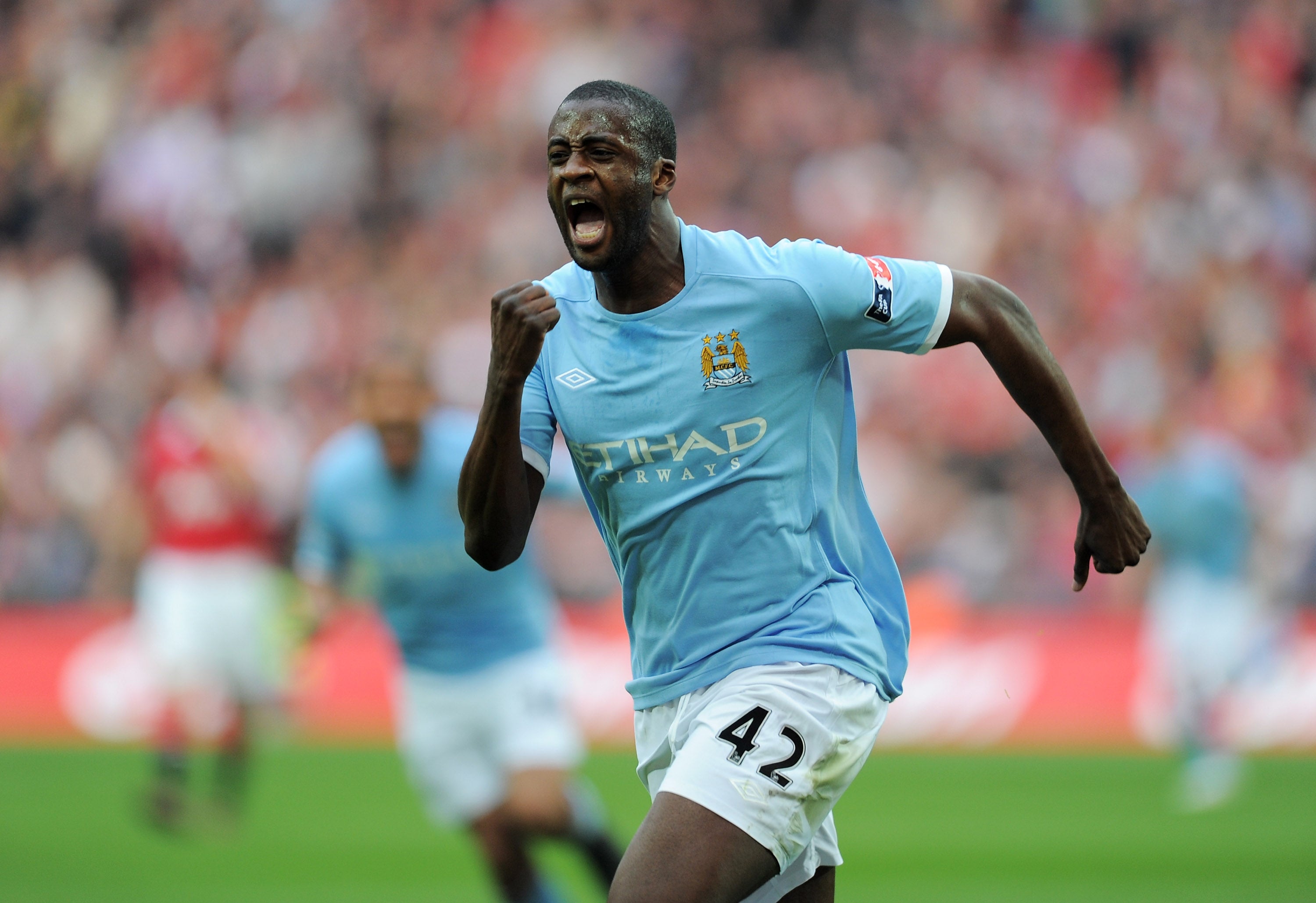 Yaya Toure celebrates scoring against Manchester United in 2011