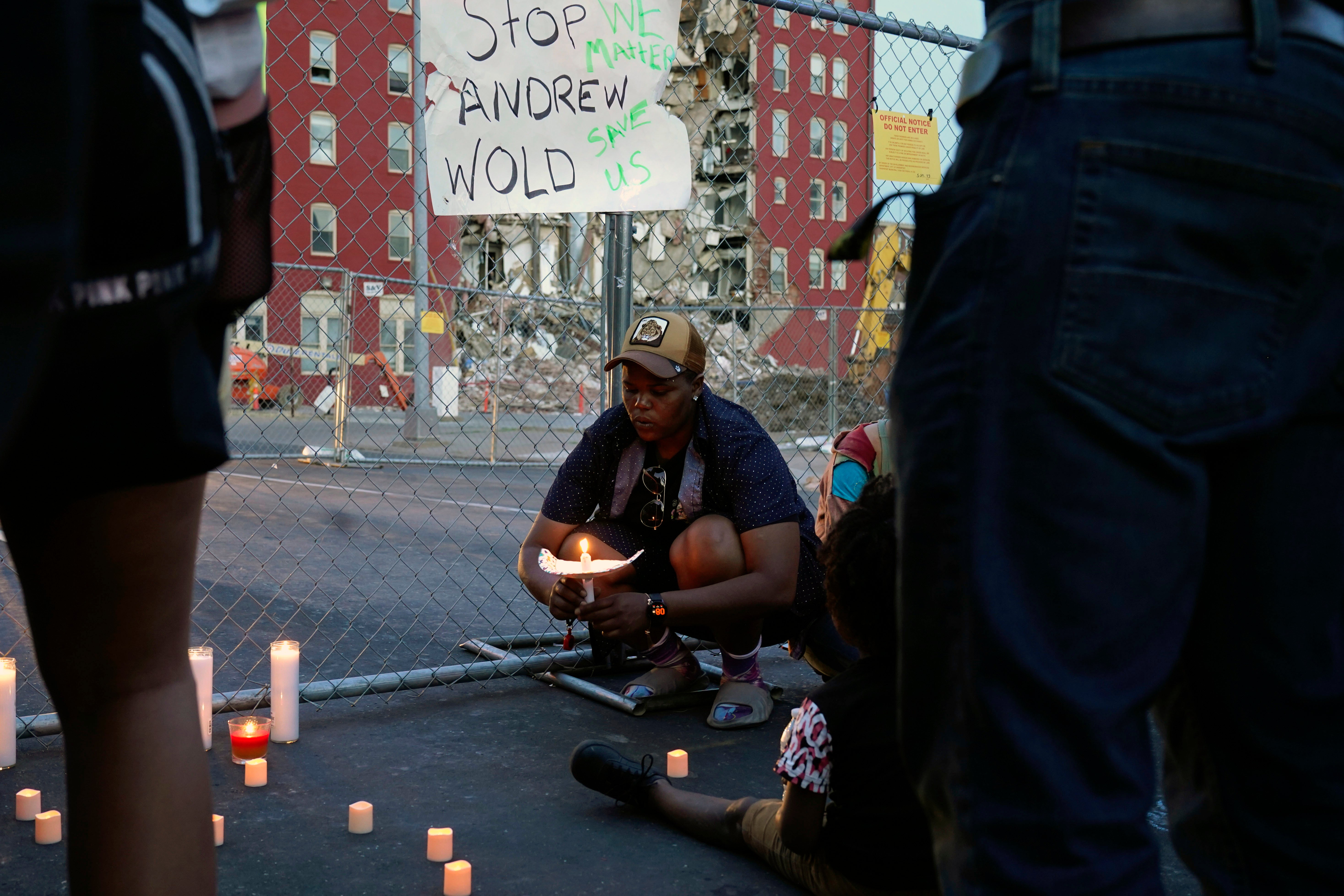 After asking a group of about 50 people gathered for a vigil to remain silent for five minutes in honor of the people feared trapped under the rubble