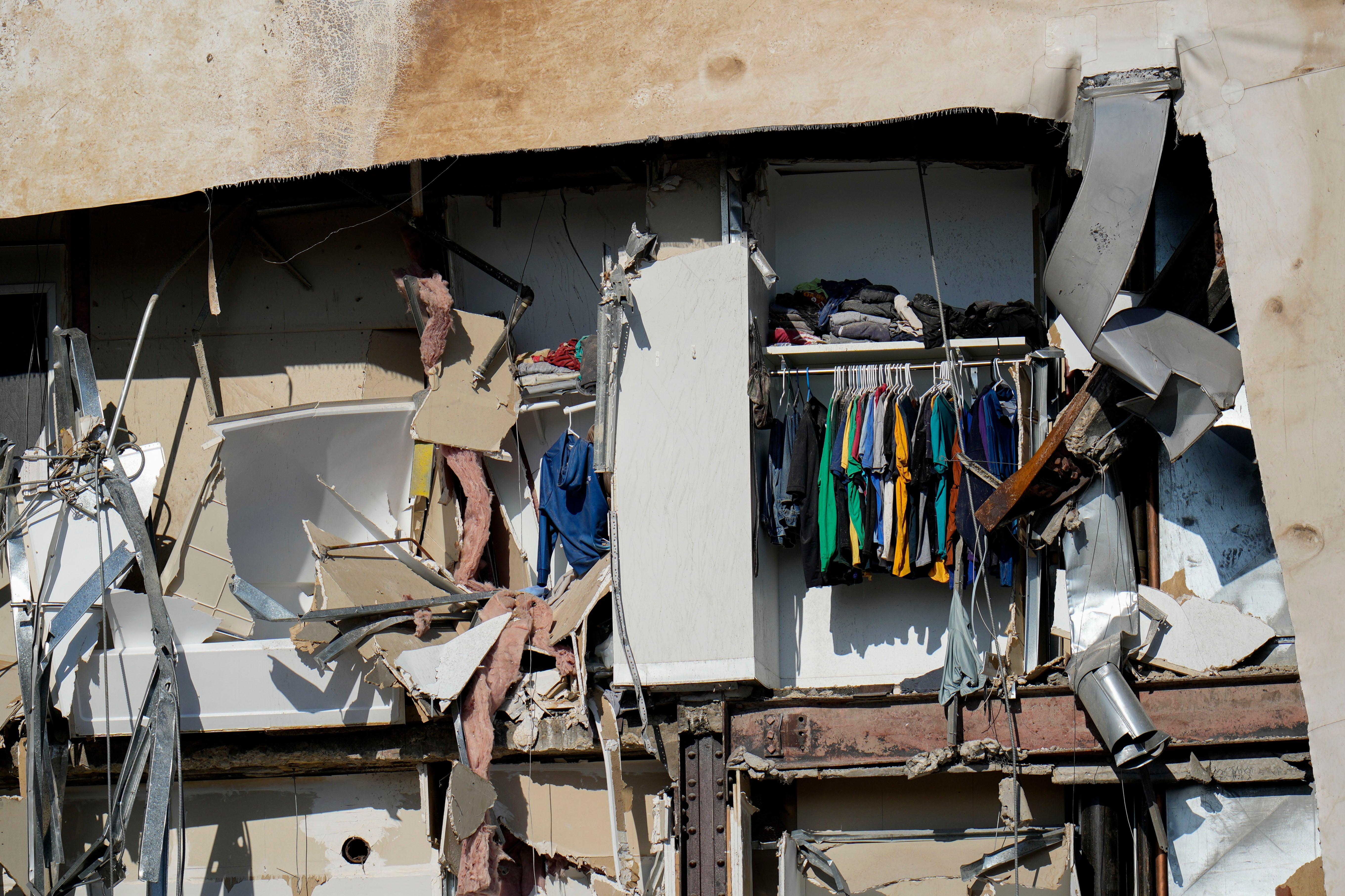 Clothing hanging in an apartment building that partially collapsed on Sunday afternoon can be seen Tuesday, May 30