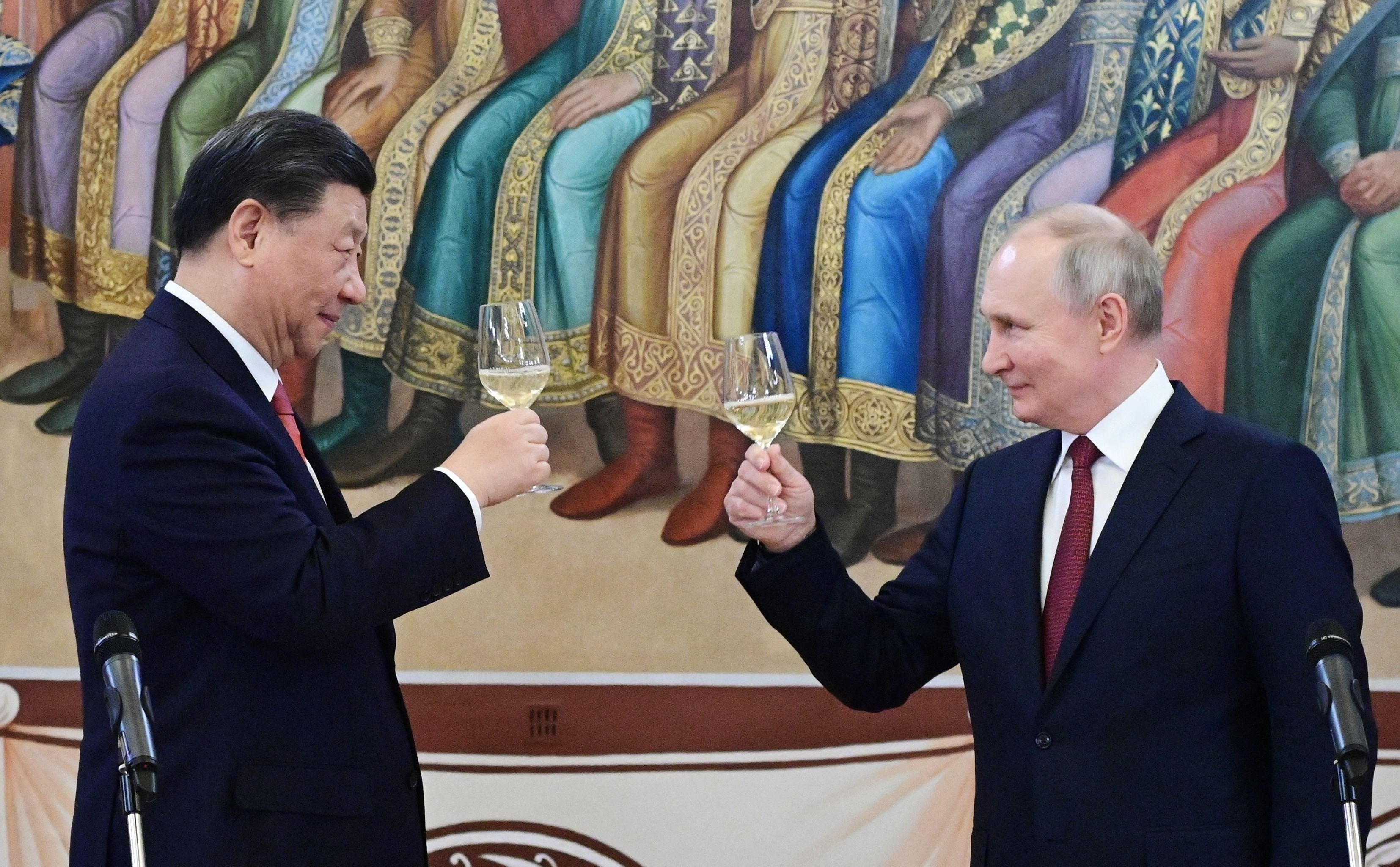 <p>Russian president Vladimir Putin and China's president Xi Jinping make a toast during a reception following their talks at the Kremlin in Moscow on 21 March</p>