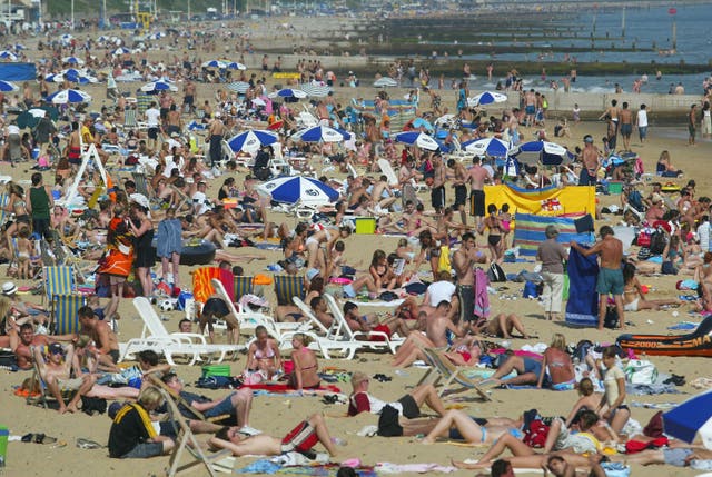 <p>People bask in the sun as temperatures reach 25C </p>
