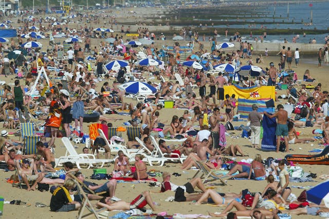 <p>People bask in the sun as temperatures reach 25C </p>