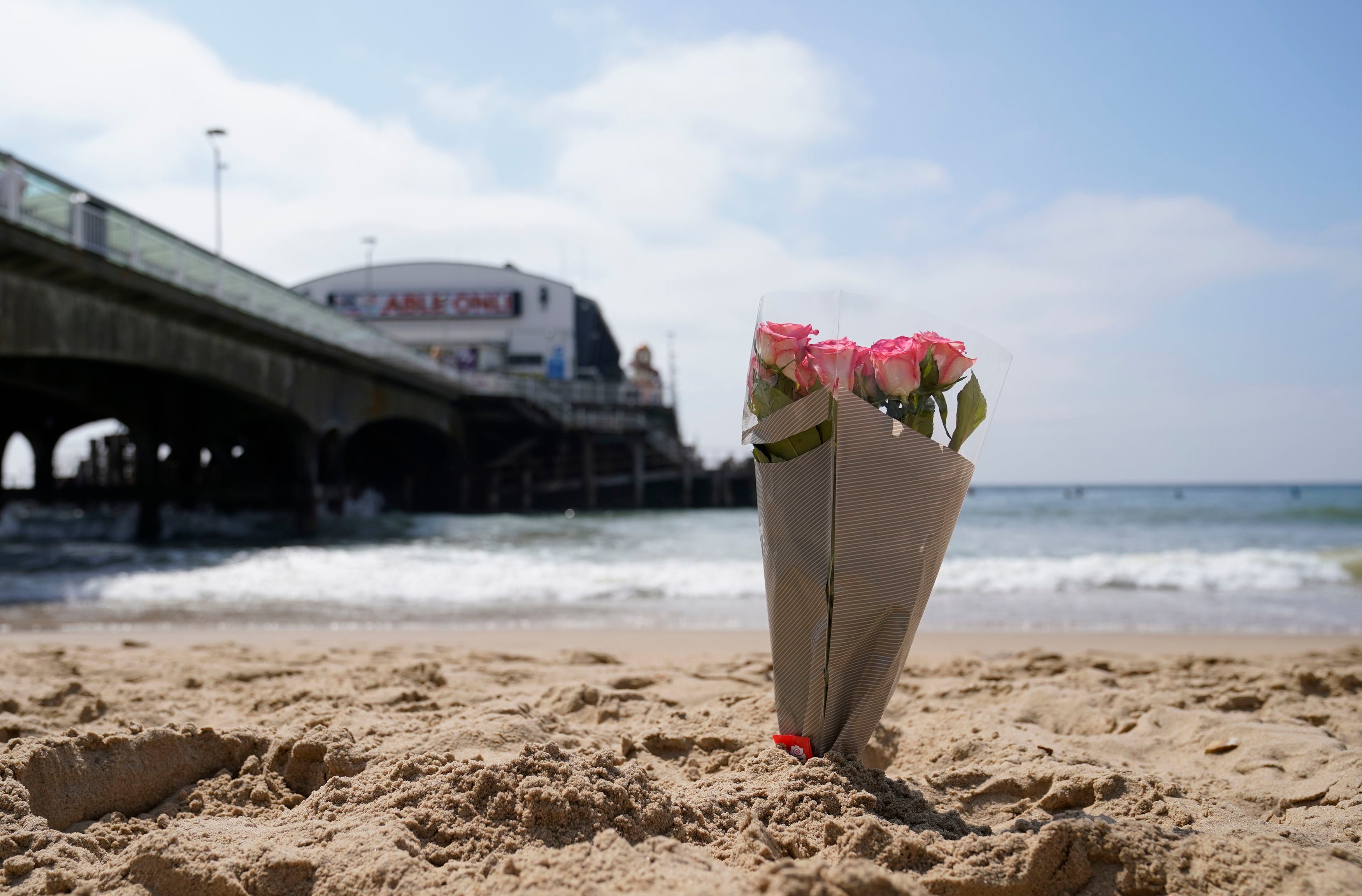 <p>A bunch of flowers left on Bournemouth beach for a 17-year-old-boy and a girl aged 12 who sustained "critical injuries" on Wednesday</p>