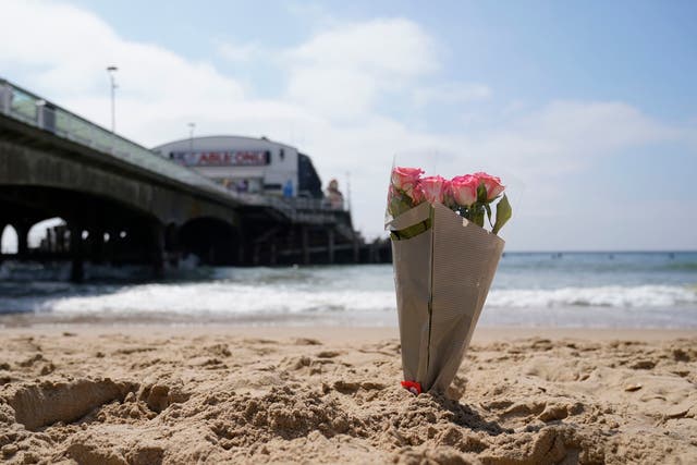<p>A bunch of flowers left on Bournemouth beach for a 17-year-old-boy and a girl aged 12 who sustained "critical injuries"</p>