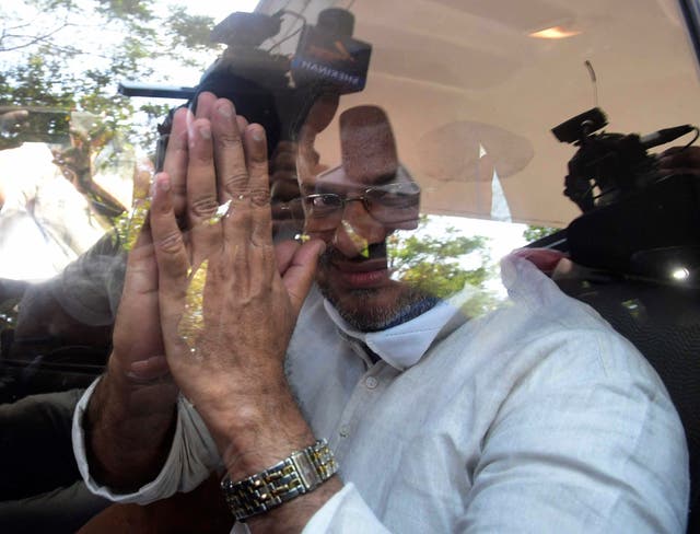 <p>Bishop Franco Mulakkal greets the media as he leaves a court in Kottayam, India on 14 January 2022 </p>