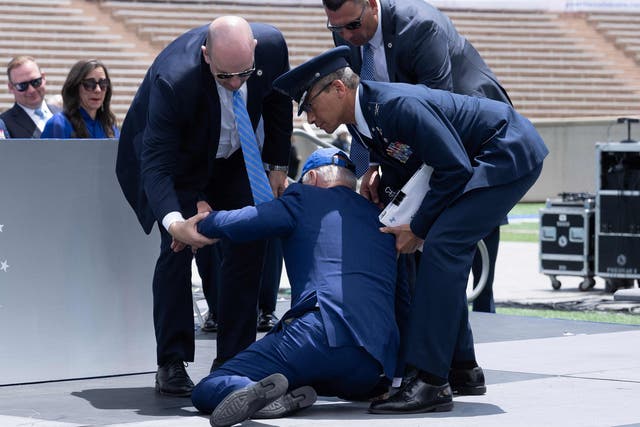 <p>US President Joe Biden is helped up after falling during the graduation ceremony at the United States Air Force Academy, just north of Colorado Springs in El Paso County, Colorado, on June 1, 2023</p>