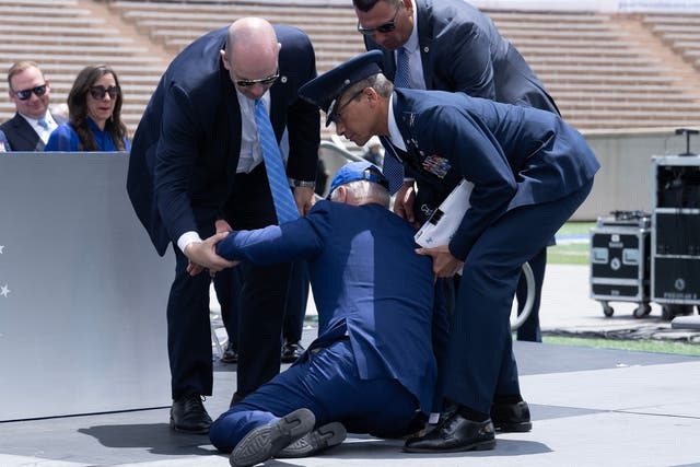 <p>US President Joe Biden is helped up after falling during the graduation ceremony at the United States Air Force Academy, just north of Colorado Springs in El Paso County, Colorado, on June 1, 2023.</p>