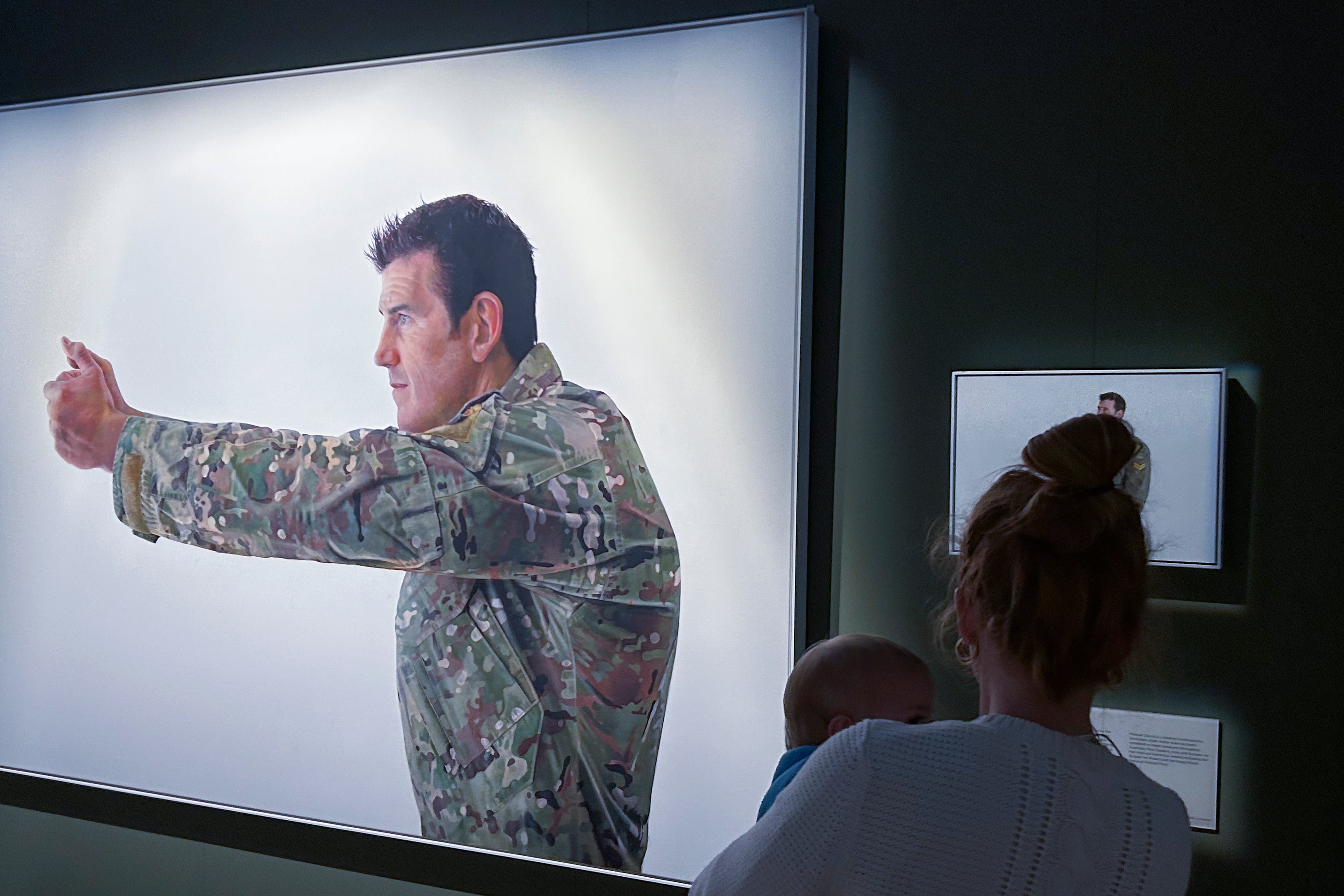 File. A visitor looks at a display featuring decorated war veteran Ben Roberts-Smith at the Australian War Memorial in Canberra, Australia, Friday, 2 June 2023