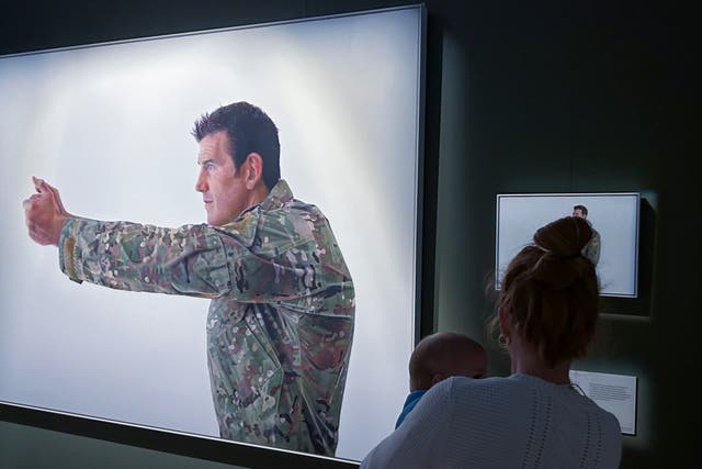 <p>File. A visitor looks at a display featuring decorated war veteran Ben Roberts-Smith at the Australian War Memorial in Canberra, Australia, Friday, 2 June 2023</p>