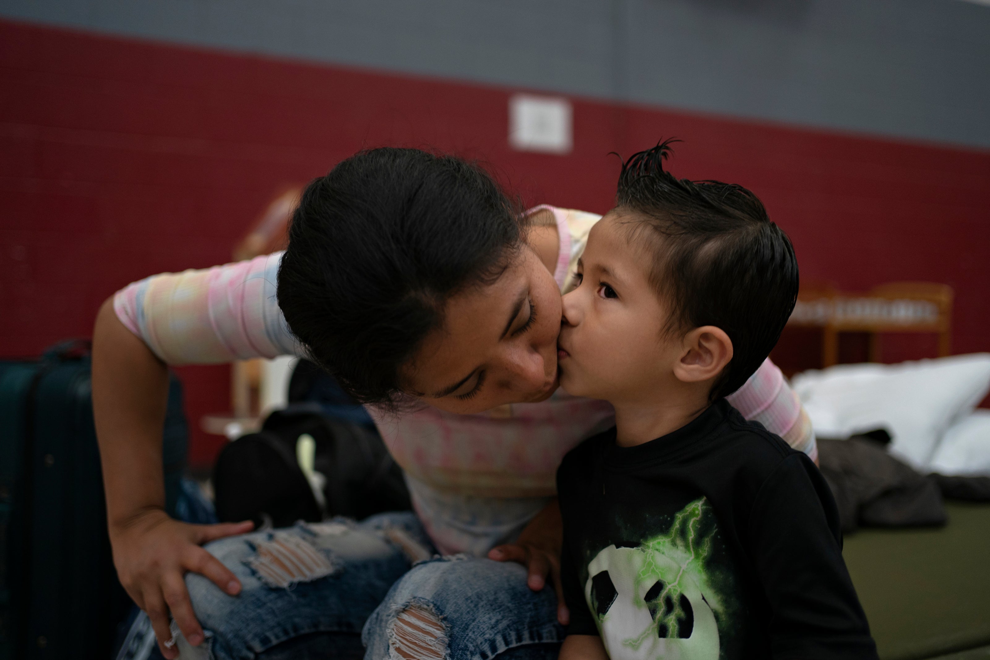 Yaneth Callejas asks for a kiss from her son at a shelter in El Paso