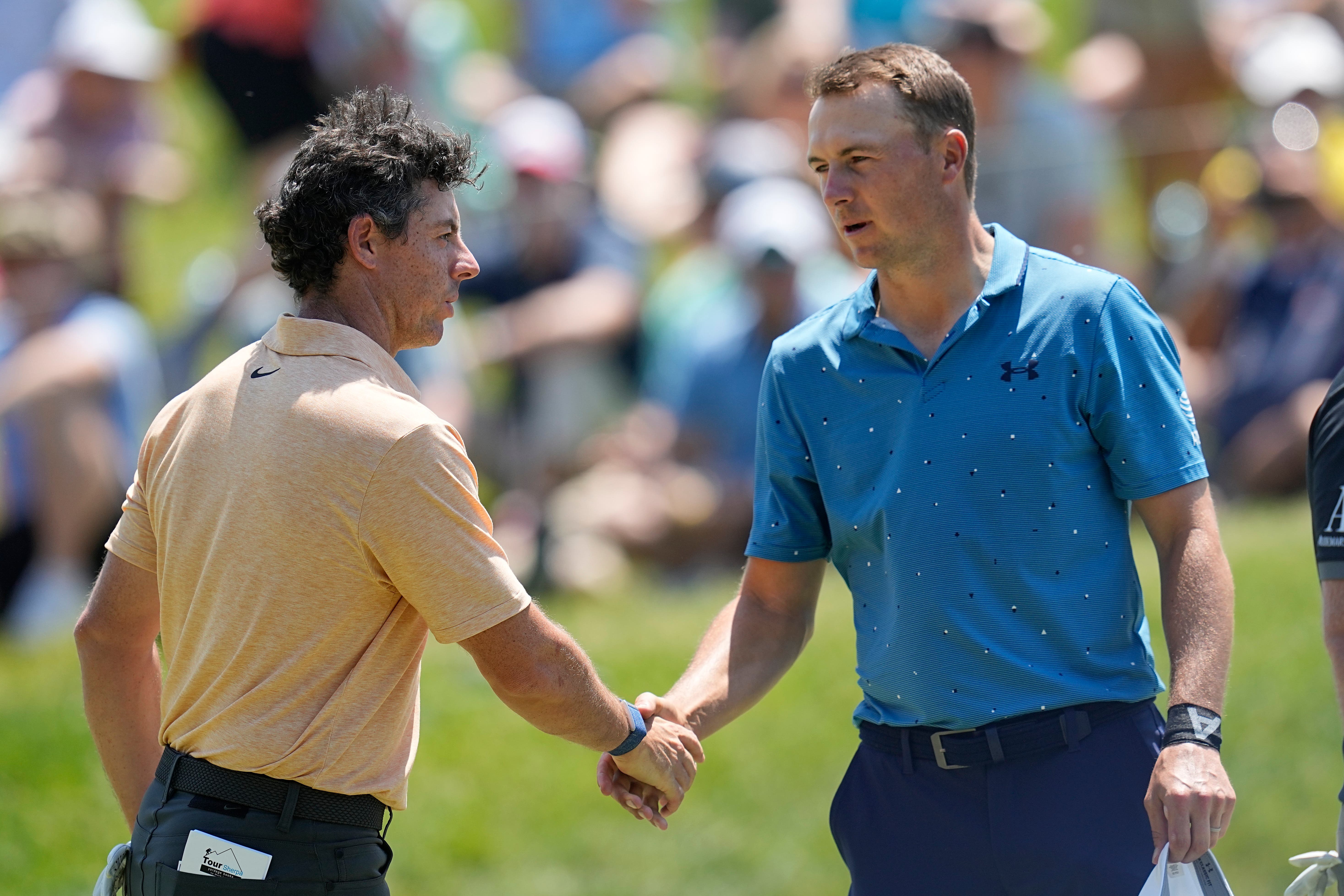 Rory McIlroy (left) and Jordan Spieth shake hands after the second round of the Memorial Tournament (Darron Cummings/AP)