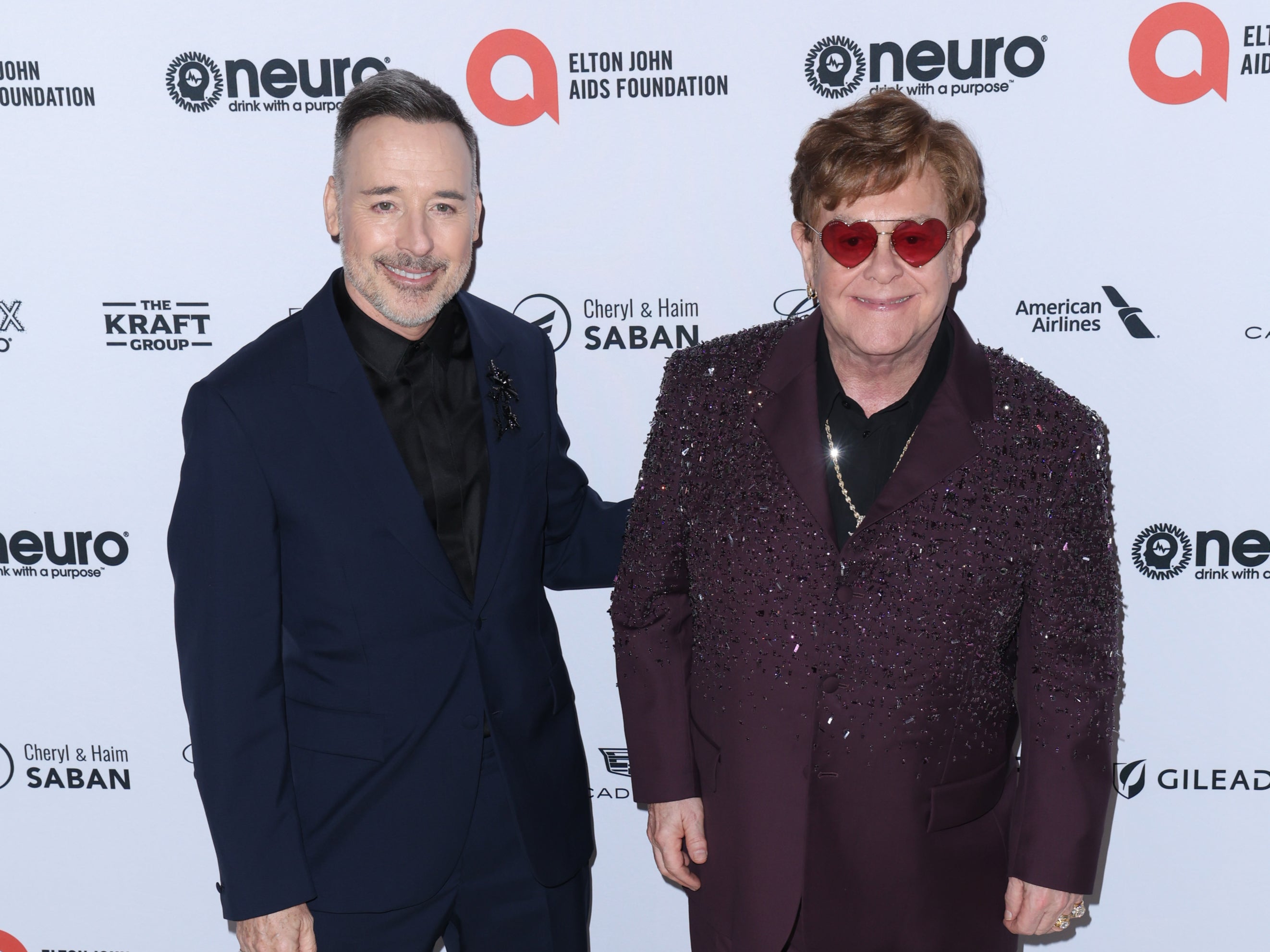 Elton John and husband David Furnish have condemned the home secretary