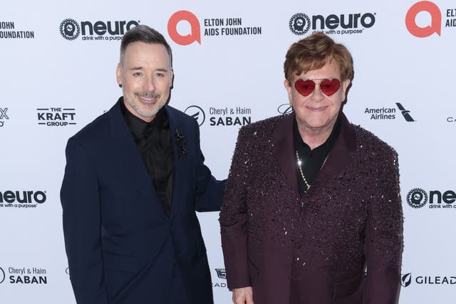 <p>David Furnish, pictured here with husband Elton in March, has condemned US politicians such as Ron DeSantis</p>