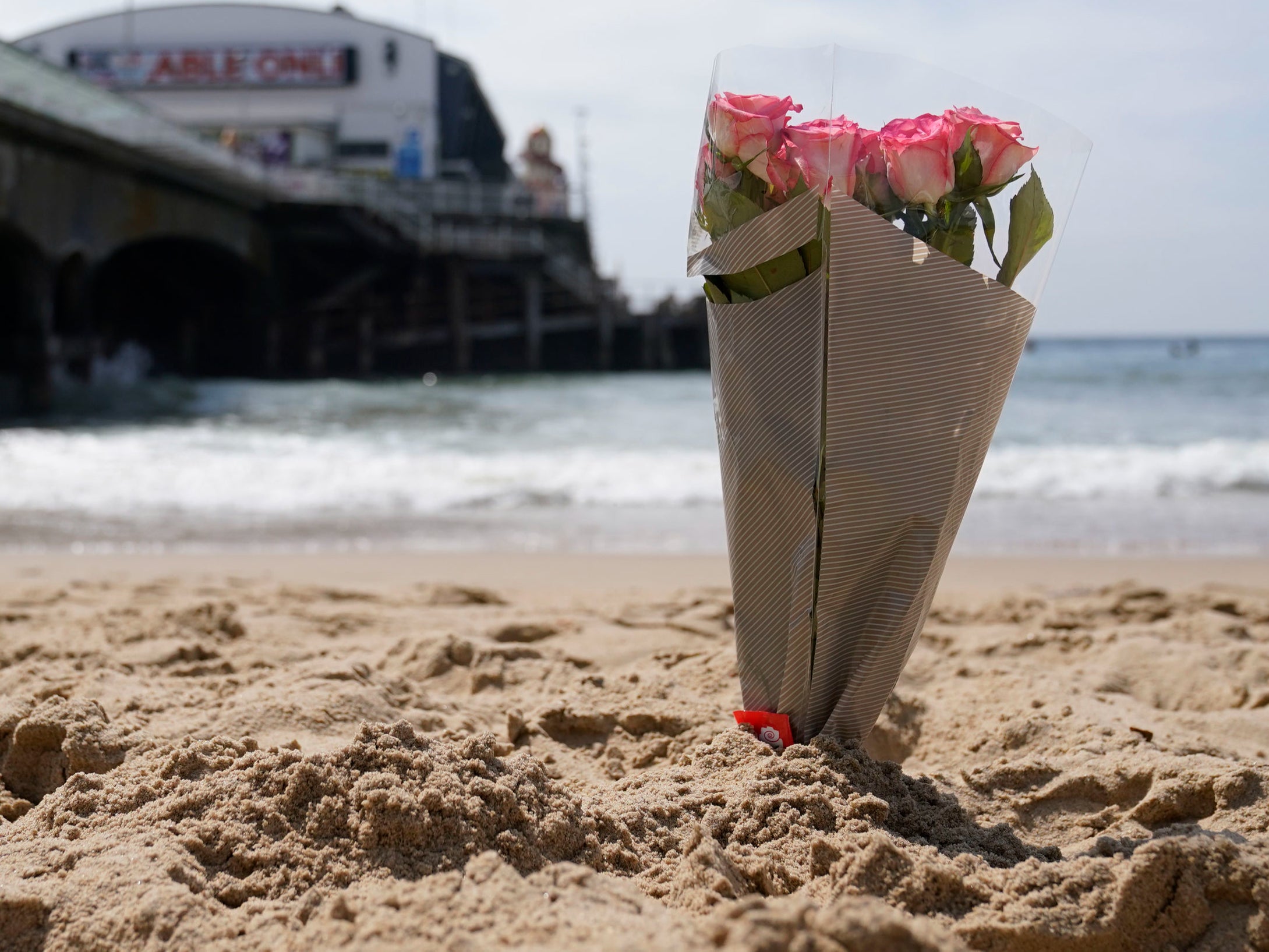 A bunch of flowers left on Bournemouth beach for a 17-year-old-boy and a girl aged 12 who died at the beach last week