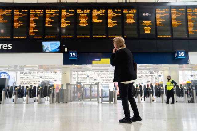 A passenger at Waterloo train station in London (James Manning/PA)