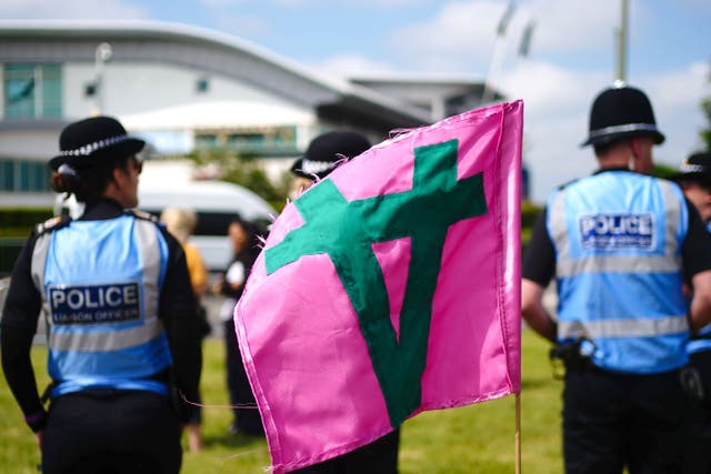 Police Liaison Officers look on in the area where Animal rights protest group Animal Rising are during Derby Day of the 2023 Derby Festival at Epsom Downs Racecourse, Epsom (Victoria Jones/PA)