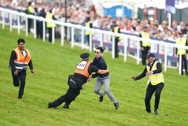 There were cheers as the protestor was tackled by police and stewards (Mike Egerton/PA)