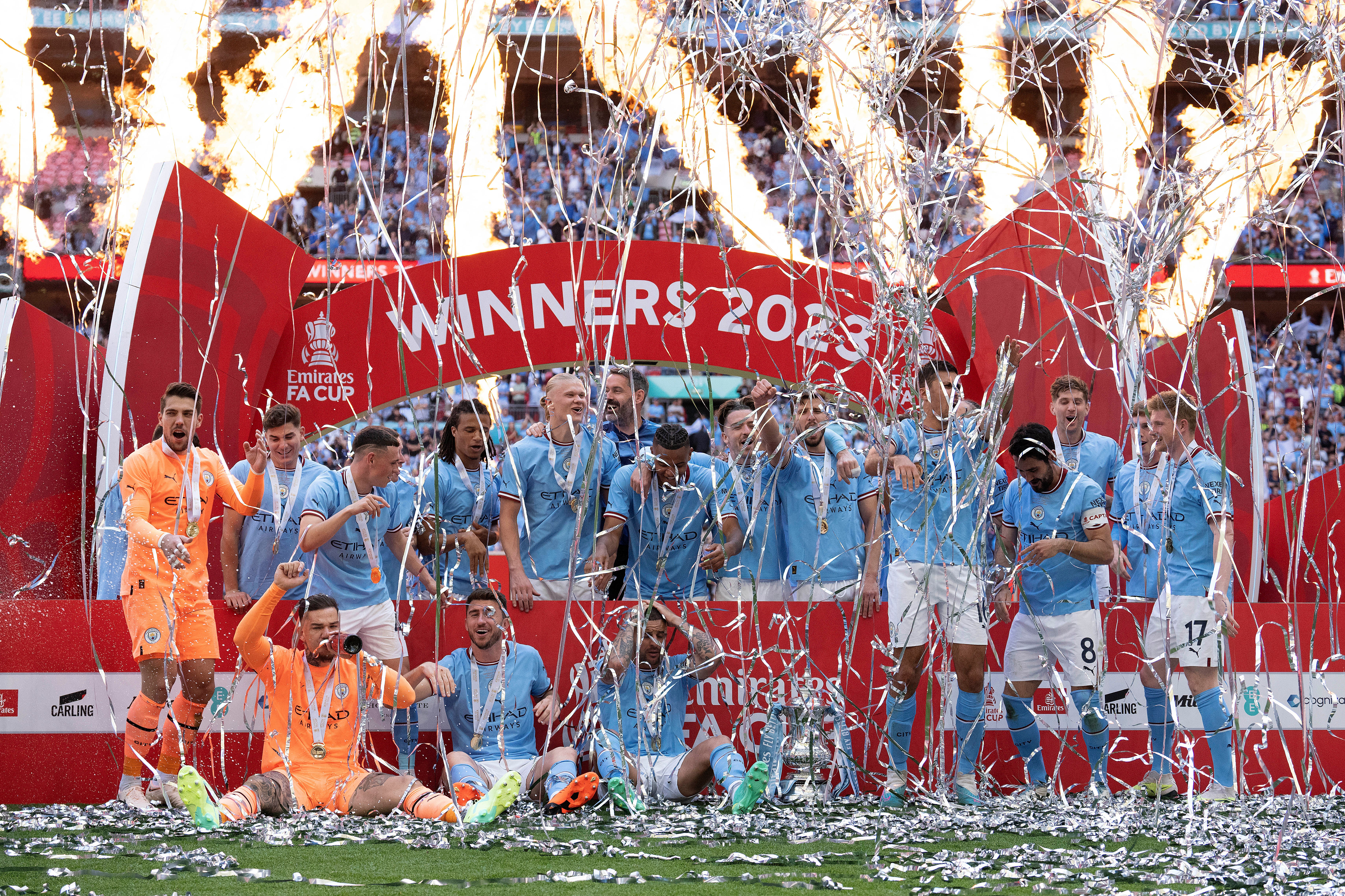 Manchester City players celebrate after winning the English FA Cup final soccer match between Manchester City and Manchester United at Wembley Stadium in London